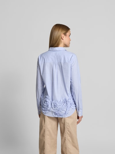 Frauenmodel trägt Regular Fit Hemdbluse mit Rüschenbesatz von BAUM & PFERDGARTEN in Hellblau, reine Baumwolle, Ganzkörperansicht Rückansicht.