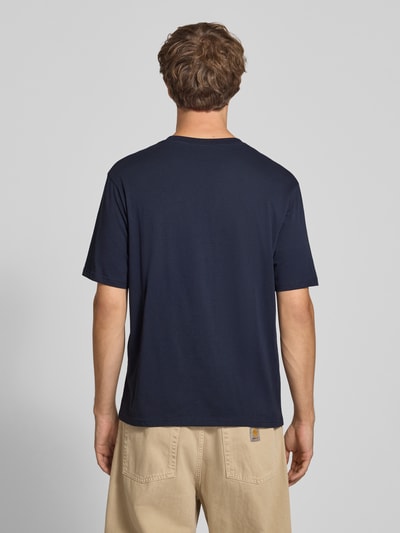 Männermodel trägt Regular Fit T-Shirt aus reiner Baumwolle Modell 'Denver' von JACK & JONES in Dunkelblau, Ganzkörperansicht Rückansicht. Herren T-Shirt, Logo-Print, Rückenlänge bei Größe M: 69 cm.
