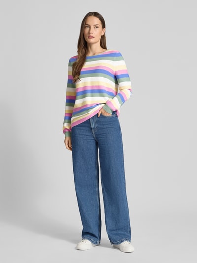 Modelka kobieca ma na sobie Strickpullover aus reiner Baumwolle od Christian Berg Woman w pastelowe paski, luźny krój, długi rękaw, okrągły dekolt, ściągacze, bawełna; luźne jeansy, białe buty; widok całej sylwetki z przodu.
