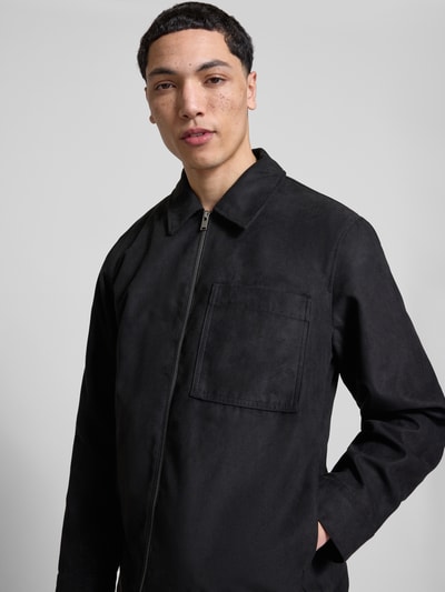 Männermodel trägt Regular Fit Jacke in Lederoptik Modell 'RICK' von Only & Sons, unifarben, Umlegekragen, Reißverschluss, Ganzkörperansicht von vorne