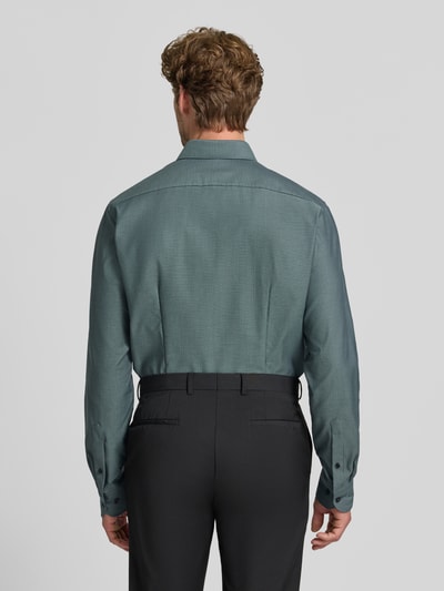 Männermodel trägt Modern Fit Businesshemd mit extra langem Arm von OLYMP in Grün, glatte Textur, Ganzkörperansicht Rückansicht, Herren Businesshemd von OLYMP