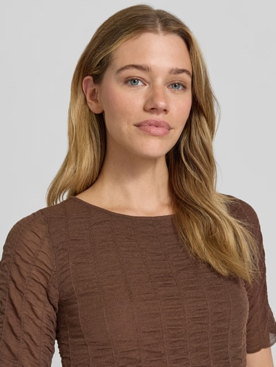 Frauenmodel trägt Strickshirt aus Viskose-Mix mit Rundhalsausschnitt von Christian Berg Woman Selection in Braun, Strukturmuster, Nahaufnahme Oberkörper.