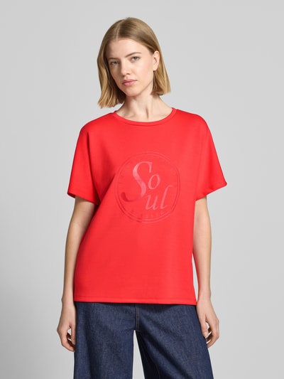 Frauenmodel trägt Damen T-Shirt mit Statement-Print Modell 'BANU' von Soyaconcept in Rot, Material-Mix mit Micromodal-Anteil, Relaxed-Fit, Rundhalsausschnitt, Ganzkörperansicht von vorne.