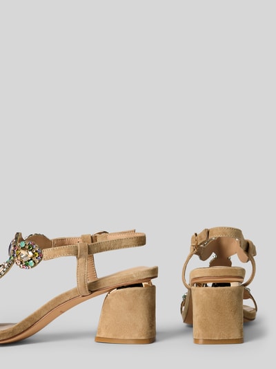 Produktfoto, Sandalette mit Ziersteinbesatz und Blockabsatz von ALMA EN PENA aus Leder-Textil-Mix, Riemen mit Dornschließe, Absatzhöhe 7 cm bei Größe 40, neutrale Sandfarbe, samtige Textur, blockige Form, Produktfoto.