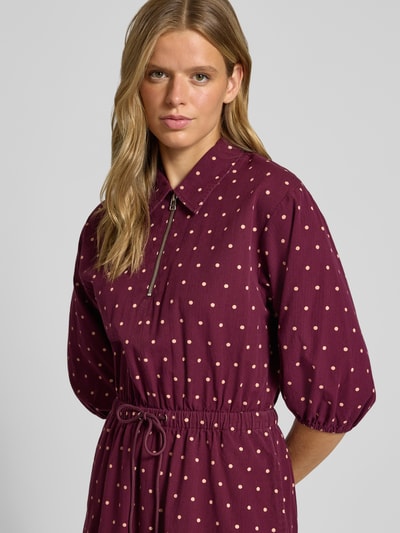 Vrouwenmodel draagt tailliertes vrijetijdsjurk uit puur katoen van MOP DENIM, all-over stippenmotief, overhemdkraag, ritssluiting, tailleband, driekwartmouwen met elastische mouwboord, uitlopende rompzoom, bordeauxrood met beige, structuurstof, Nahaufnahme bovenlichaam.