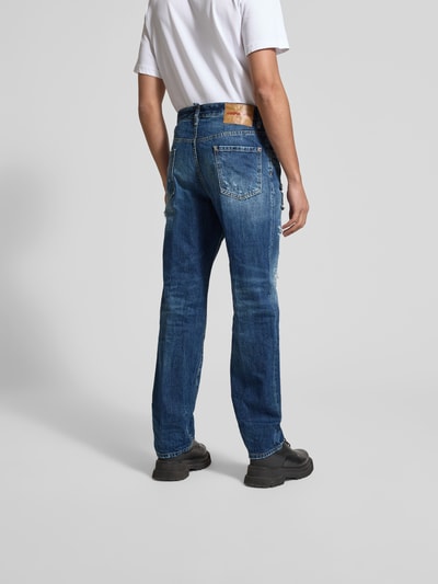 Männermodel trägt Slim Fit Jeans aus reiner Baumwolle von Dsquared2 im Destroyed-Look, 5-Pocket-Design, Ganzkörperansicht Rückansicht.