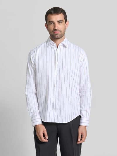 Männermodel trägt Loose Fit Freizeithemd mit Kentkragen Modell 'Miles' von JOOP! aus reiner Baumwolle, Allover-Look, Ganzkörperansicht von vorne.