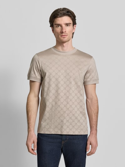 Männermodel trägt Regular Fit T-Shirt mit Rundhalsausschnitt Modell 'Davison' von JOOP! Collection, beige mit Muster, Ganzkörperansicht von vorne.
