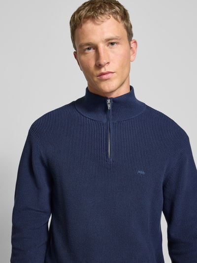 Männermodel trägt Regular Fit Troyer in Strick-Optik von Levi's®, Reine Baumwolle, Logo-Stitching, Troyer-Kragen, Nahaufnahme Oberkörper.