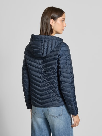 Frauenmodel trägt Regular Fit Steppjacke mit Kapuzenkragen von Tom Tailor in Dunkelblau, leichte Steppstruktur, Ganzkörperansicht Rückansicht, Damen Steppjacke von Tom Tailor