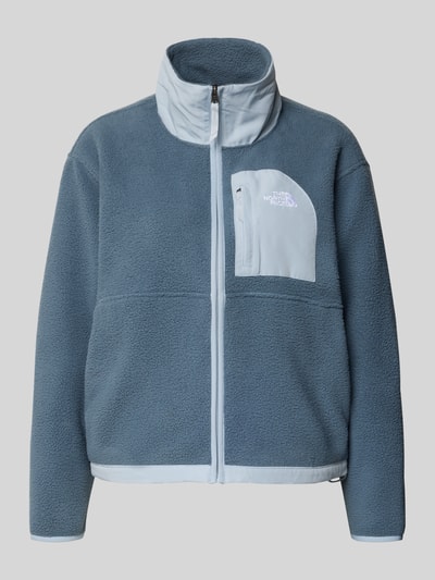 Produktfoto, Fleecejacke mit Stehkragen und Label-Stitching von The North Face, kolor niebieskoszary, krój regular fit, kieszeń na piersi na zamek, długość tyłu w rozmiarze S: 57 cm, szerokość ramion w rozmiarze S: 50 cm, szerokość w rozmiarze S: 56 cm, długość rękawa w rozmiarze S: 56 cm, tekstura polarowa