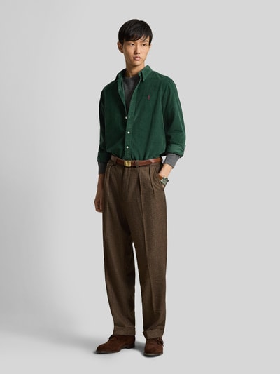 Männermodel trägt Custom Fit Freizeithemd aus reiner Baumwolle von Polo Ralph Lauren in Dunkelgrün, gerade Formen, matter Stoff, Ganzkörperansicht von vorne. Herren Freizeithemd von Polo Ralph Lauren.