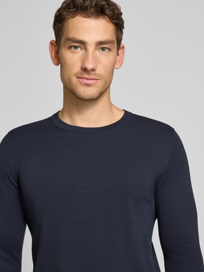 Mężczyznę model nosi Slim Fit Pullover in Strick-Optik Modell 'Mino' od Drykorn, bawełna, krój slim fit, okrągły dekolt, kolor granatowy, tekstura dzianiny, kontekst: długość tyłu w rozmiarze M 72 cm, długość rękawa w rozmiarze M 70 cm, zbliżenie na górną część ciała