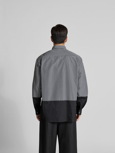 Männermodel trägt Relaxed Fit Freizeithemd mit Brusttasche von VETEMENTS aus Baumwoll-Mix, Unifarbenes-Design, Ganzkörperansicht Rückansicht.