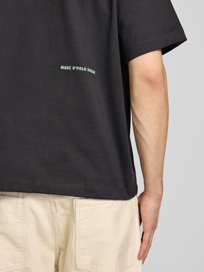 Männermodel trägt Boxy Fit T-Shirt aus reiner Baumwolle von Marc O'Polo Denim, Optik: Unifarben, Label-Print, Nahaufnahme Rückenbereich.