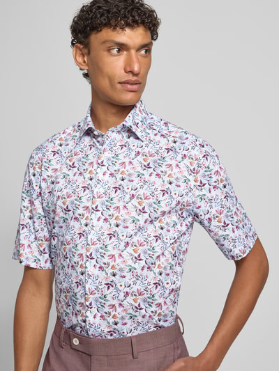 Männermodel trägt Regular Fit Business-Hemd mit floralem Muster und Kentkragen von OLYMP, bunte Farben, reine Baumwolle, Nahaufnahme Oberkörper.