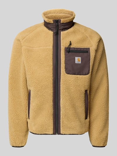 Produktfoto, beige Fleecejacke mit brauner Brusttasche und Reißverschlüssen, Modell 'PRENTIS LINER' von Carhartt Work In Progress, Regular Fit, Stehkragen, Label-Patch, strukturierte Oberfläche.