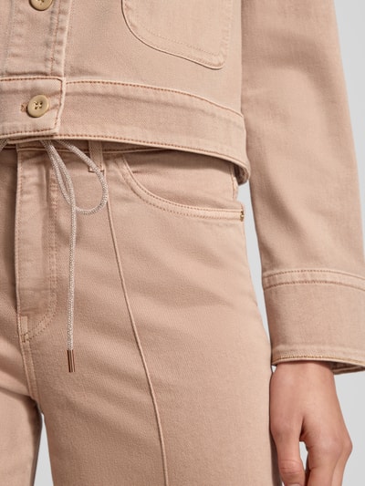 Kobiece modelka nosi Wide Leg Jeans mit 5-Pocket-Design od Marc Cain z bawełniano-elastycznego materiału w jasnym kolorze, widoczne kieszenie, pasek ze sznurka, szerokość w rozmiarze 36: 36 cm, długość nogawki: 83 cm, detaliczny widok na biodra i pas, zbliżenie.