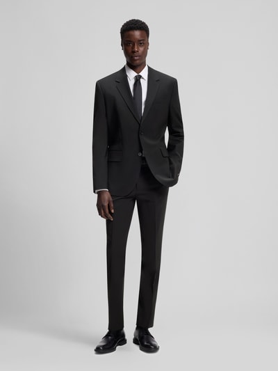 Mannenmodel draagt Slim Fit Anzughose aus Woll-Mix Modell 'HESTEN' van HUGO, uni melange look, smalle fit, steekzakken, wolmix, frontale volledige lichaamsweergave.