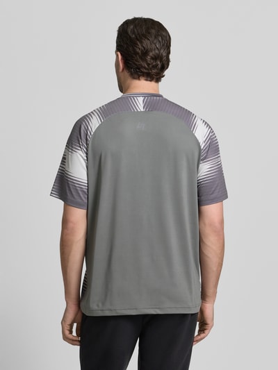 Männermodel trägt Regular Fit T-Shirt mit Logo-Applikation von EA7 Emporio Armani in Grau, elastischer Material-Mix, Ganzkörperansicht Rückansicht.