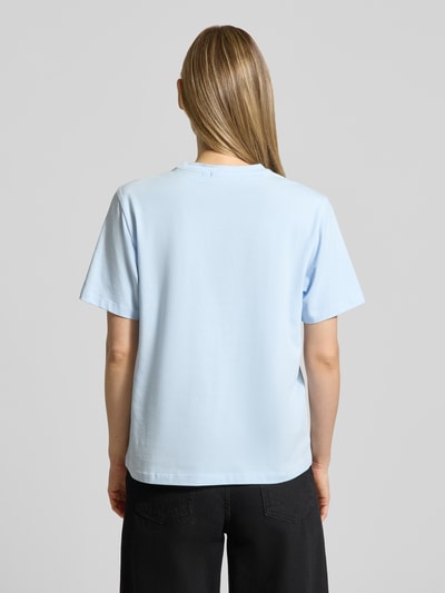 Frauenmodel trägt T-Shirt mit Stitching Modell 'NORA' von Vila in Hellblau, Baumwoll-Elasthan-Mix, Regular-Fit, Rückenlänge 58 cm, Ganzkörperansicht Rückansicht.
