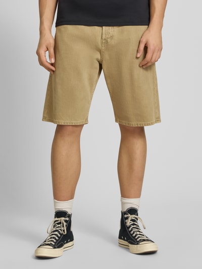 Männermodel trägt Baggy Fit Jeansshorts Modell 'ALEX' von Jack & Jones in Beige, reine Baumwolle, Eingrifftaschen, Ganzkörperansicht von vorne.