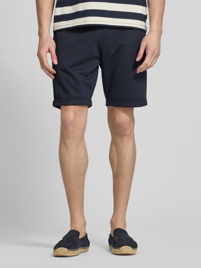 Männermodel trägt Sweatshorts mit elastischem Bund und Gesäßtasche von MCNEAL, dunkelblau, Regular Fit, Nahaufnahme Unterkörper, Vorderansicht.