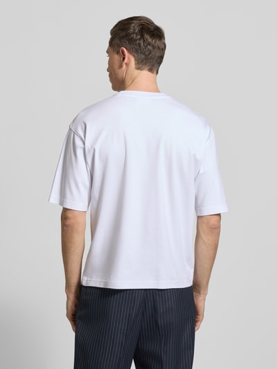 Männermodel trägt weißes Relaxed Fit T-Shirt aus reiner Bio-Baumwolle von JAKE*S STUDIO MEN, Ganzkörperansicht Rückansicht.