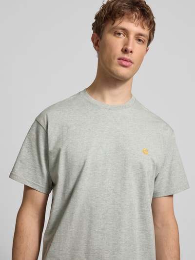 Männermodel trägt Regular Fit T-Shirt mit Logo-Stitching Modell 'Chase' von Carhartt Work In Progress aus Baumwolle, Nahaufnahme Oberkörper.