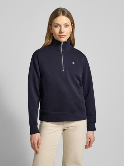 Frauenmodel trägt Sweatshirt mit Baumwoll-Anteil von Gant in Dunkelblau, Baumwoll-Mix, Lockerer-Schnitt, Troyer-Kragen, Label-Stitching, gerippte Abschlüsse, Ganzkörperansicht von vorne.