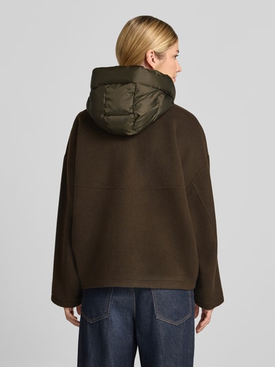 Frauenmodel trägt Doubleface Wolljacke mit abnehmbarer Steppkapuze von Blonde No. 8 in Dunkelbraun, lockere Passform, Rückenansicht.