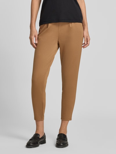 Frauenmodel trägt Slim Fit Hose mit Viskose-Anteil Modell 'KATE' von ICHI in Braun, verkürzte Passform, Nahaufnahme Unterkörper. Elastischer Bund, schlichte Textur, Damen Hose von ICHI, elastischer Material-Mix mit Viskose-Anteil, Tunnelzug, Bundweite Größe S 38 cm, Innenbeinlänge S 63 cm.