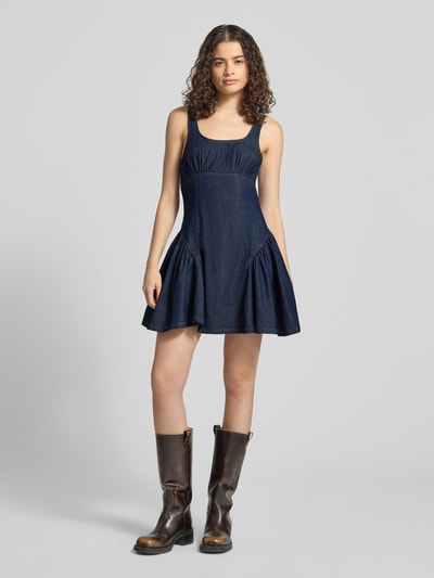 Frauenmodel trägt Minikleid in Denim-Optik Modell 'Eva' von Topshop aus reiner Baumwolle, taillierte Passform, ärmelloses-Design, Ganzkörperansicht von vorne.