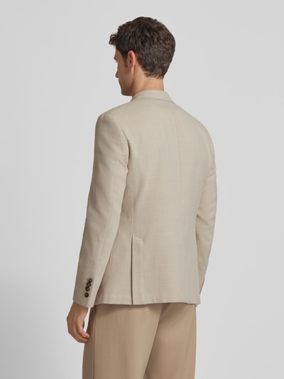Männermodel trägt Slim Fit Sakko aus Schurwoll-Baumwoll-Mix Modell 'Heazy' von JOOP! Collection in Beige, feine Struktur, Ganzkörperansicht Rückansicht. Rückenlänge 73 cm, Schulterbreite 42 cm, Ärmellänge 63 cm, Zweireiher, Reverskragen, aufgesetzte Taschen.