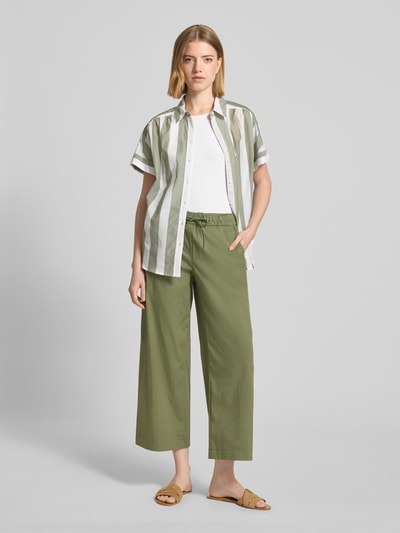 Frauenmodel trägt Regular Fit Bluse aus reiner Baumwolle von Brax mit Two-Tone-Optik, gestreiftem Muster, Kurzarm, Hemdblusenkragen, einreihiger Knopfleiste, glatter Struktur, Ganzkörperansicht von vorne.