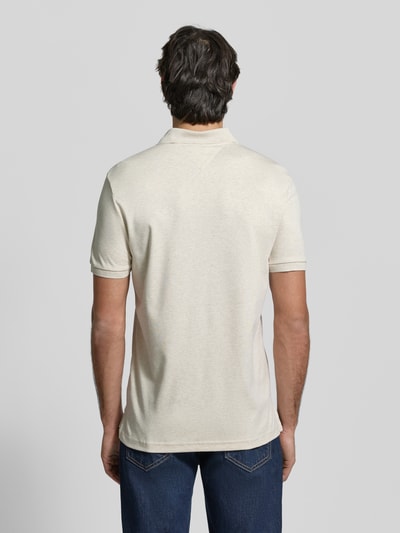 Männermodel trägt Regular Fit Poloshirt aus reiner Baumwolle Modell 'LIQUID COTTON' von Tommy Hilfiger, Melange-Optik, Ganzkörperansicht Rückansicht.