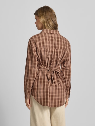 Frauenmodel trägt Oversized Hemdbluse mit Label-Detail Modell 'Lilia' von OH APRIL aus Reine Baumwolle, kariert, Rückenlänge 78 cm, Ganzkörperansicht Rückansicht.