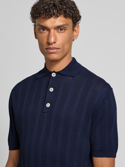 Männermodel trägt Slim Fit Poloshirt mit Knopfleiste von Manuel Ritz in Dunkelblau mit Strukturmuster aus reiner Baumwolle, Nahaufnahme Oberkörper.