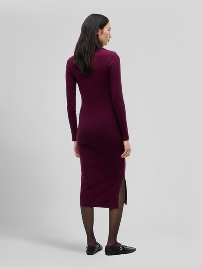 Frauenmodel trägt Eng anliegendes Freizeitkleid aus Baumwoll-Mix von Tommy Jeans in Dunkelrot, Ganzkörperansicht Rückansicht. Damen Freizeitkleid von Tommy Jeans