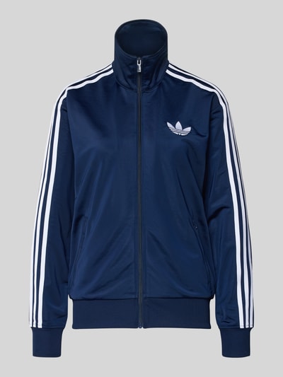 Produktfoto, Sweatjacke mit Stehkragen van adidas Originals in donkerblauw met witte strepen, losse pasvorm, met ribboorden en ritszakken.