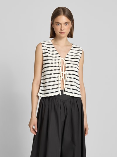Frauenmodel trägt Regular Fit Weste mit Baumwoll-Anteil Modell 'EVA LIFE' von Only im Allover-Muster, Strick, V-Ausschnitt, Bindeband, Nahaufnahme Oberkörper.