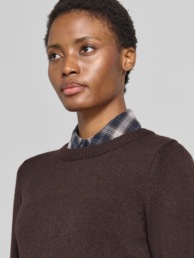 Frauenmodel trägt Strickpullover aus Viskose-Mix von VILA in Dunkelbraun, gerippter Rundhalsausschnitt, Nahaufnahme Oberkörper.