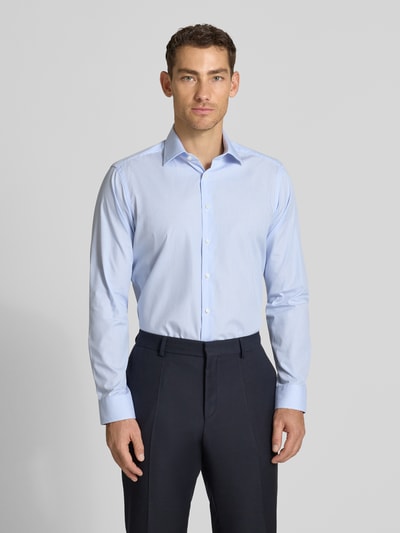 Männermodel trägt Regular Fit Business-Hemd aus Baumwolle mit Kentkragen von Christian Berg Men, hellblau, Knopfleiste, Ganzkörperansicht von vorne. Rückenlänge bei Größe 39/40: 81 cm, Schulterbreite: 40 cm, Ärmellänge: 66 cm.