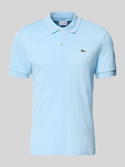 Produktfoto, Regular Fit Poloshirt aus reiner Baumwolle von Lacoste w kolorze jasnoniebieskim, efekt: jednolity kolor, krój regular fit, detal z logo, kołnierzyk polo, dekolt w serek, krótkie zapięcie na guziki, krótki rękaw z prążkowanym zakończeniem, wykończenie z bocznymi rozcięciami, asymetryczny dół, materiał: czysta bawełna