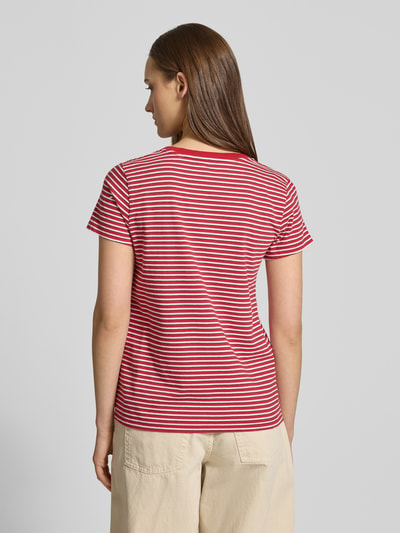 Modelka kobieta nosi T-Shirt mit V-Ausschnitt und Label-Stitching od Levi's®, bawełna, krój regular fit, widok całej sylwetki od tyłu.