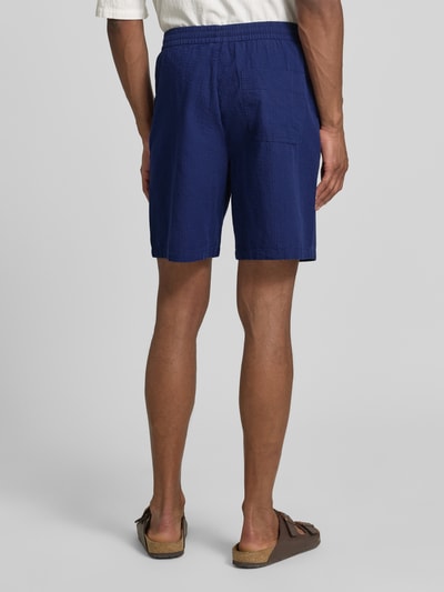 Männermodel trägt Regular Fit Shorts aus reiner Baumwolle Modell 'STUART' von SELECTED HOMME, Optik: Unifarben, Materialverarbeitung: Seersucker, Ganzkörperansicht Rückansicht.