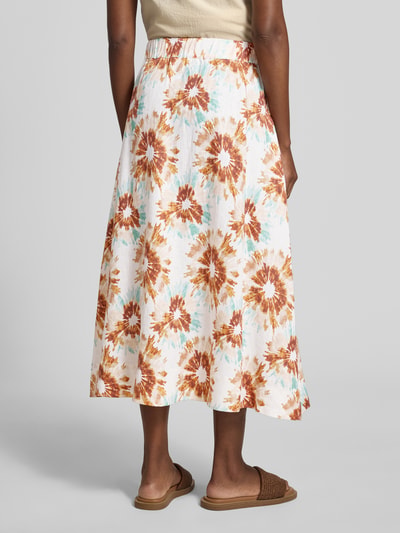 Frauenmodel trägt Midirock aus reinen Leinen Modell 'Clair' von Christian Berg Woman mit Floraler-Allover-Print, A-Linie, Elastischer-Bund, leichte Struktur, Farben Weiß, Braun und Blau, Gesamtlänge 88 cm bei Größe 36, Ganzkörperansicht Rückansicht.