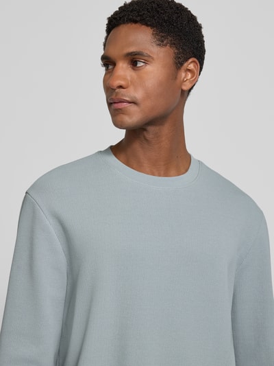 Männermodel trägt Regular Fit Langarmshirt aus Baumwoll-Mix Modell 'WE-TEMPEST' von BOSS Orange, Optik: Unifarben, Feinripp, Nahaufnahme Oberkörper.