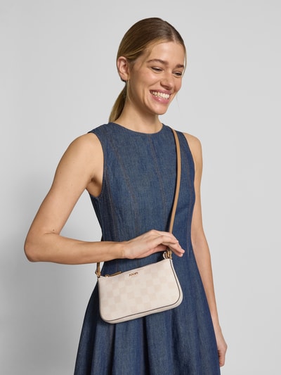 Frauenmodel trägt Handtasche mit Label-Applikation Modell 'cloe' von JOOP! in Beige mit Schulterriemen, Hauptfach mit Reißverschluss, Ganzkörperansicht von vorne.