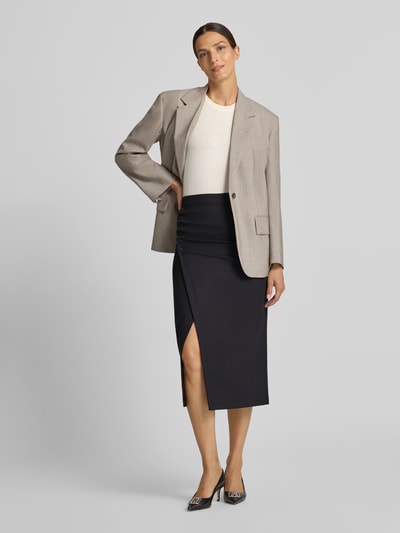 Frauenmodel trägt Midirock mit Viskose-Anteil von Armani in Schwarz, körpernahe Passform, Wickel-Optik, Blazer, Ganzkörperansicht von vorne. Elastischer Material-Mix, Zierknopfleiste am Bund, Nahtreißverschluss rückseitig.